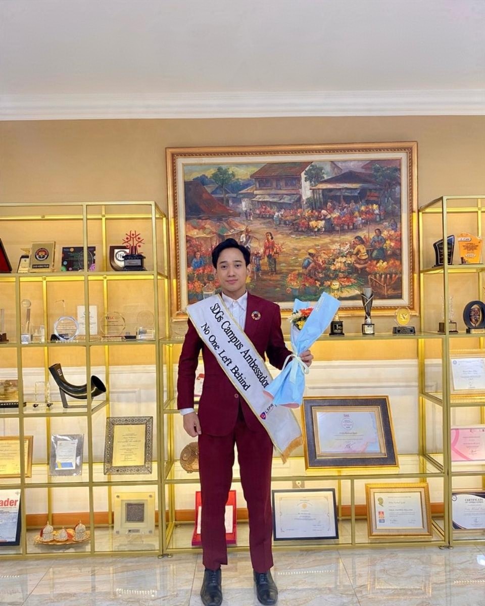Receiving a sash at a ceremony