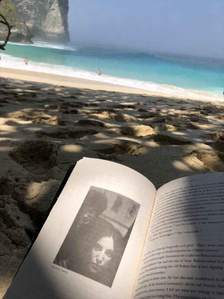 A book open on a white sand beach