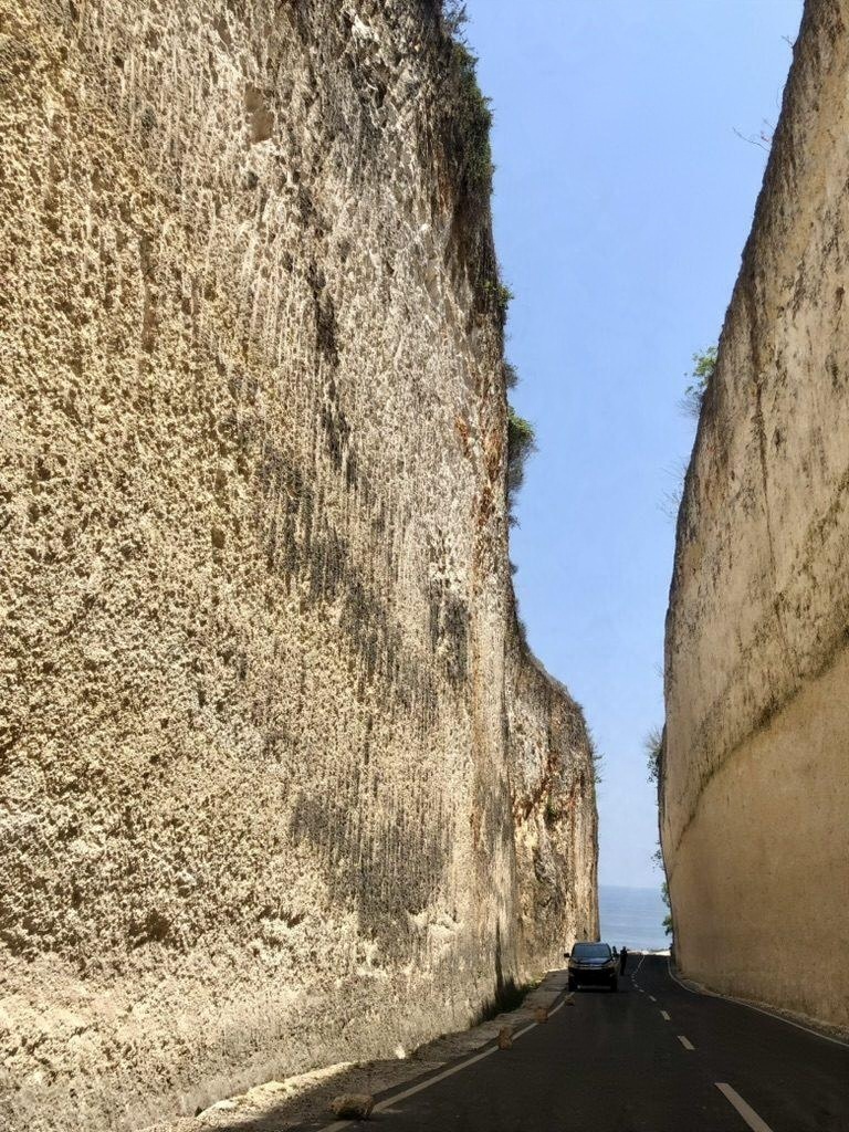 A road between tall limestone cliffs
