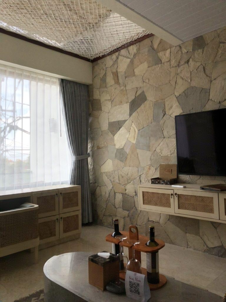 A villa living room with a stone wall