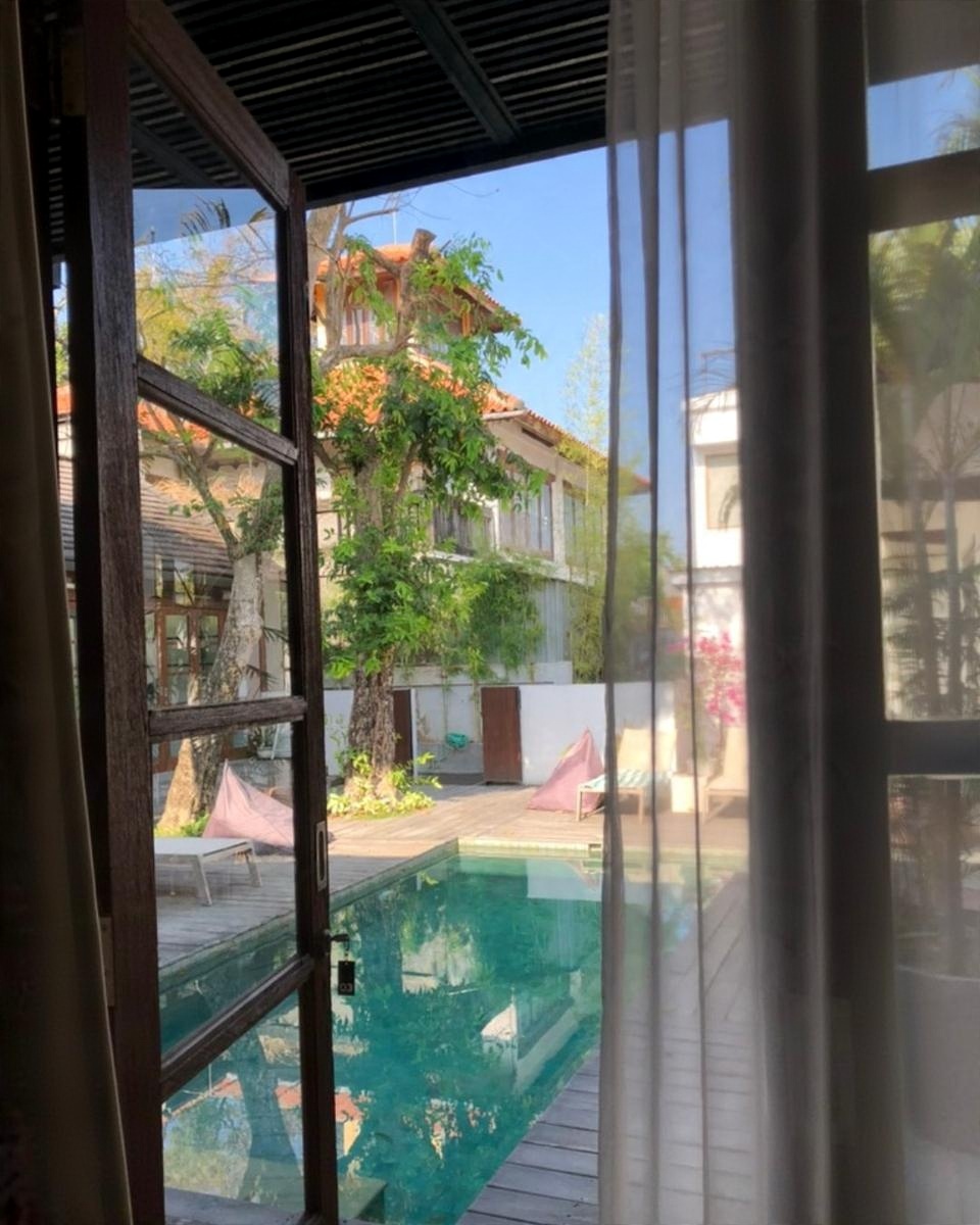 Looking out from a room onto a pool